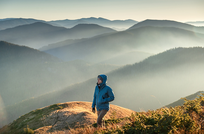 Young Man Trail Hiking In The Mountains At Sunrise, Nehrovets', Zakarpattia Oblast, Ukraine, by Cavan Images / Artur Abramiv