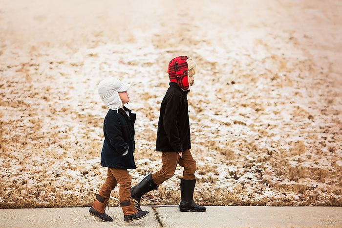 two little boys walking wearing hats and boots with snow behind them, Atlanta, Georgia, United States, by Cavan Images / Jamie Sapp