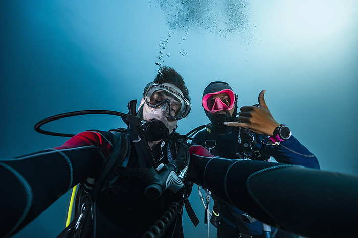 divers taking selfie on safety stop in Alor / Indonesia, Batulolong, Nusa Tenggara Timur, Indonesia, by Cavan Images / Henn Photography