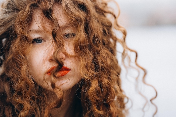 Curly redhead young woman in Prague, cloudy, Prague, Prague, Czechia, by Cavan Images / Vetrana