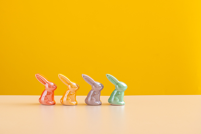 Easter concept backdrop. Cheerful Ceramic Bunnies on Yellow., London, England, United Kingdom, by Cavan Images / Galigrafiya