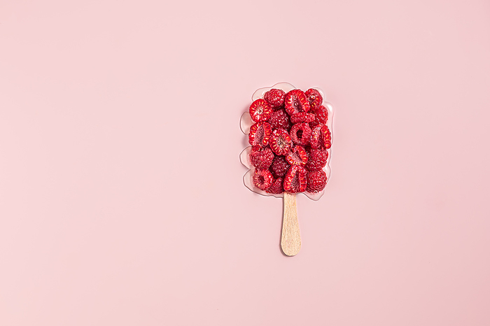 Raspberry Popsicle Shape on Pink. Healthy summer concept, New York, New York, United States, by Cavan Images / Galigrafiya