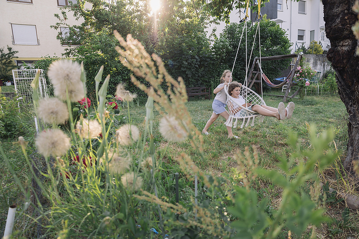 two teenage  play in the summer garden near the house. Country life., Mainz, Rhineland-Palatinate, Germany, by Cavan Images / Alena Kinderfotografin