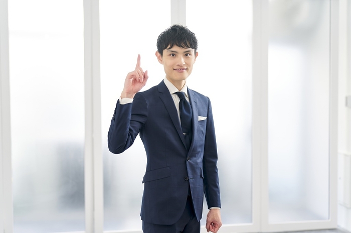 Japanese businessman pointing while wearing a custom-made suit (Male / People)