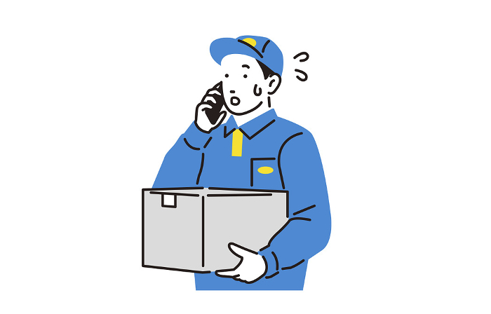 A delivery person answering the phone while carrying a package