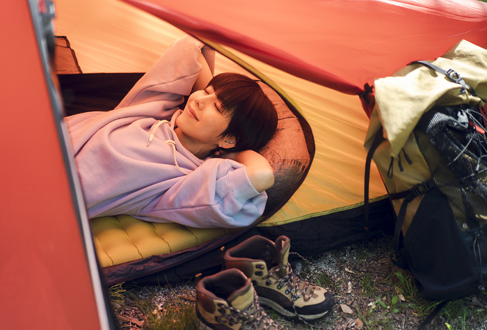 Young Japanese woman camping solo.