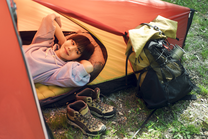 Young Japanese woman camping solo.