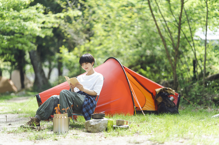 Japanese woman reading in camp (People)