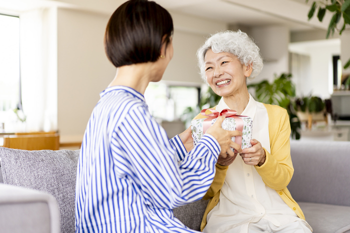 Senior Japanese woman receiving a gift (People)