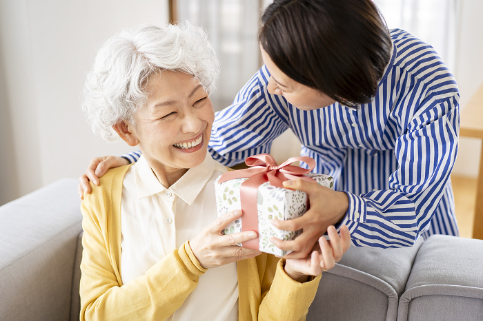 Japanese woman receiving a gift (People)