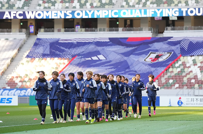Women s Soccer: Asian Final Qualifying Round for the Paris Olympics   Japan s Preparation for the 2nd Round  Japan Women s National Soccer Team Practice The players warm up with a big flag in the shape of a uniform in the background.