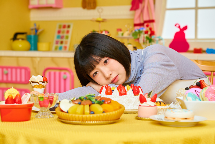 Young woman surrounded by sweets