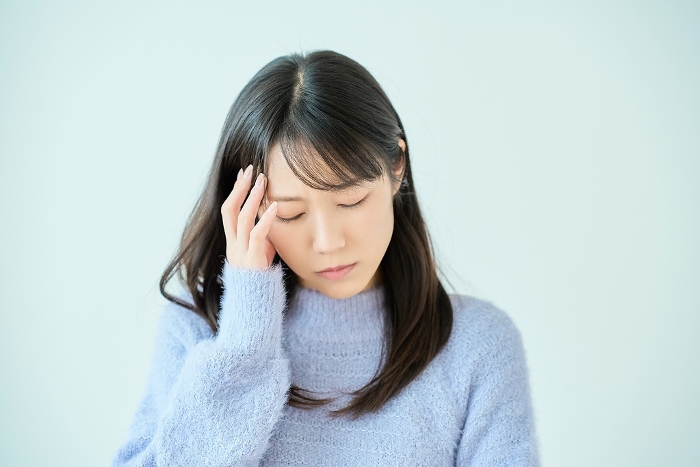 Young Japanese woman suffering from headache (People)