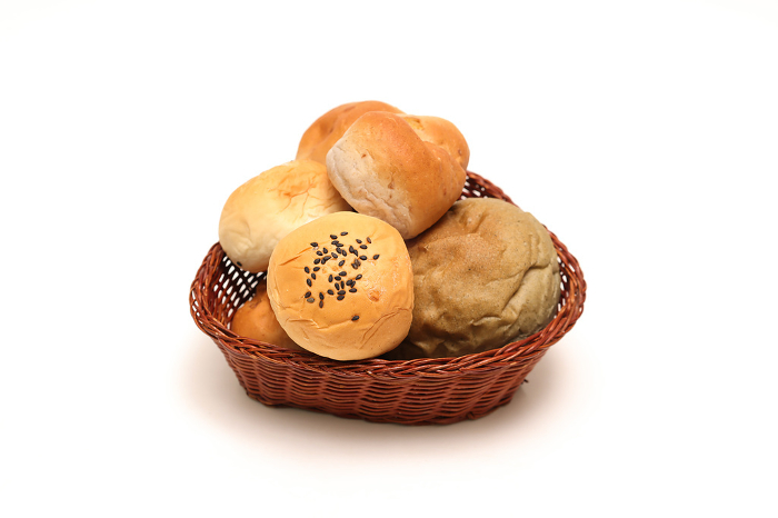 Various breads in baskets on white background