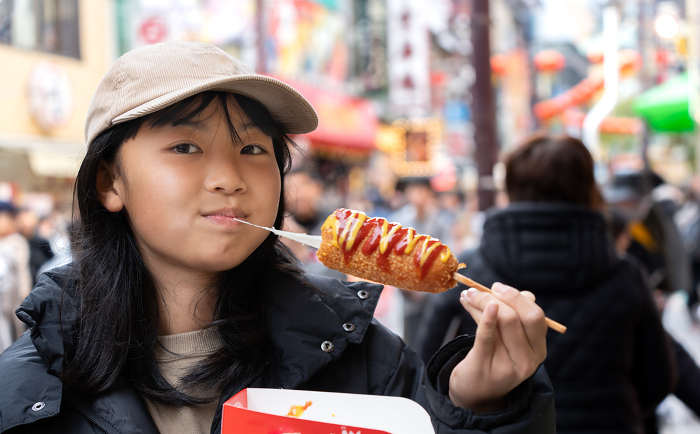 Japanese woman eating in Yokohama Chinatown