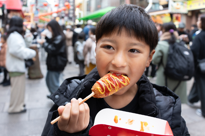 Japanese boy eating in Yokohama Chinatown