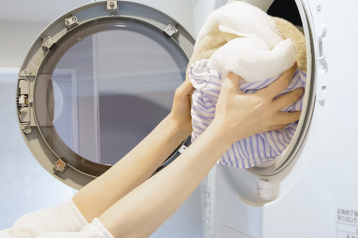 Woman taking laundry out of dryer