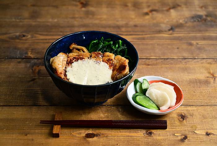 Bowl of rice topped with pork and mayo cheese sauce