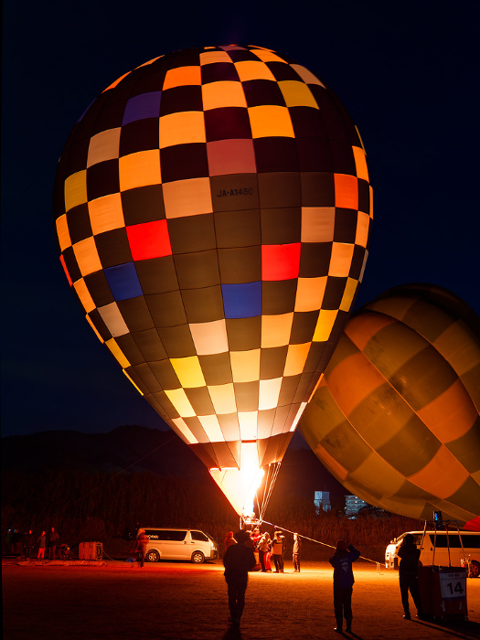 Hot air balloons lit at night at the Kameoka Balloon Fiesta