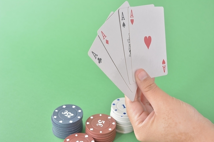 Four aces in a hand with various denomination poker chips on a green felt background, poker cards and chips, by carlos l vives