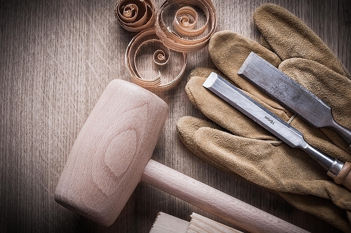 Wooden bricks hammer curled up planning chips firmer chisels leather gloves on wood board construction concept, by Dzmitri Mikhaltsow