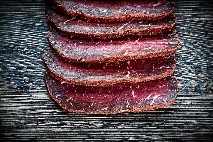 Sliced steak on a wooden board, by Dzmitri Mikhaltsow
