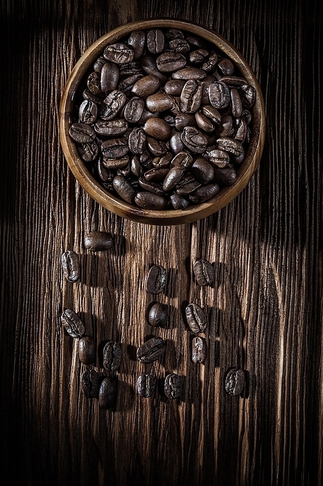 Bowl with coffee seeds on a vintage wooden board, by Dzmitri Mikhaltsow