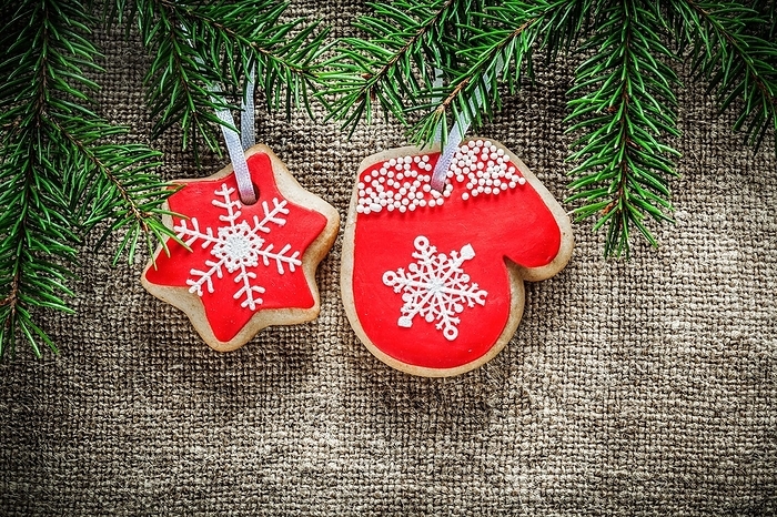 Fir branches Christmas gingerbread biscuits on sacks background, by Dzmitri Mikhaltsow