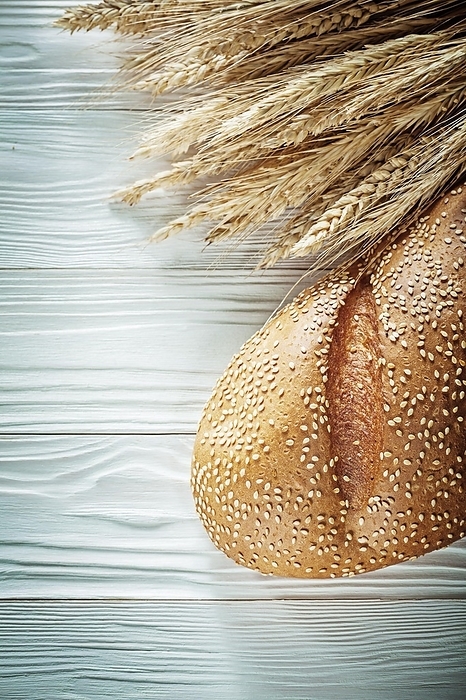 Ears of bread wheat on a white wooden board, by Dzmitri Mikhaltsow