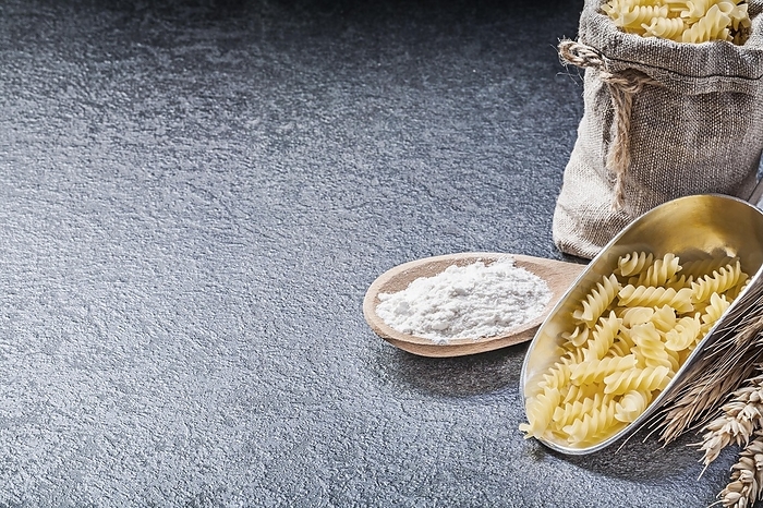 Burlap sack uncooked pasta kitchen shovel wooden spoon flour wheat rye ears on black background, by Dzmitri Mikhaltsow