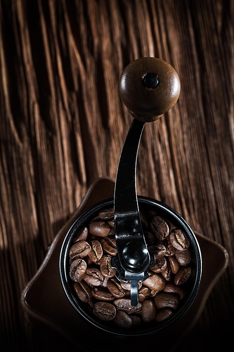 Coffee grinder natural beans on vintage wooden board, by Dzmitri Mikhaltsow