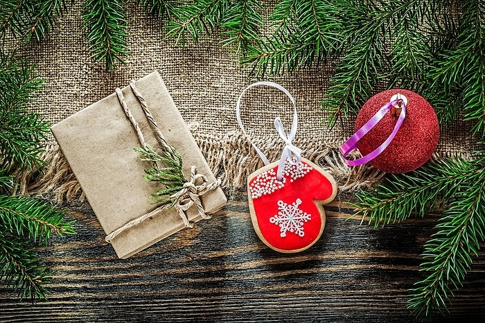 Fir branch bag Christmas bauble gingerbread gift box on wooden board, by Dzmitri Mikhaltsow