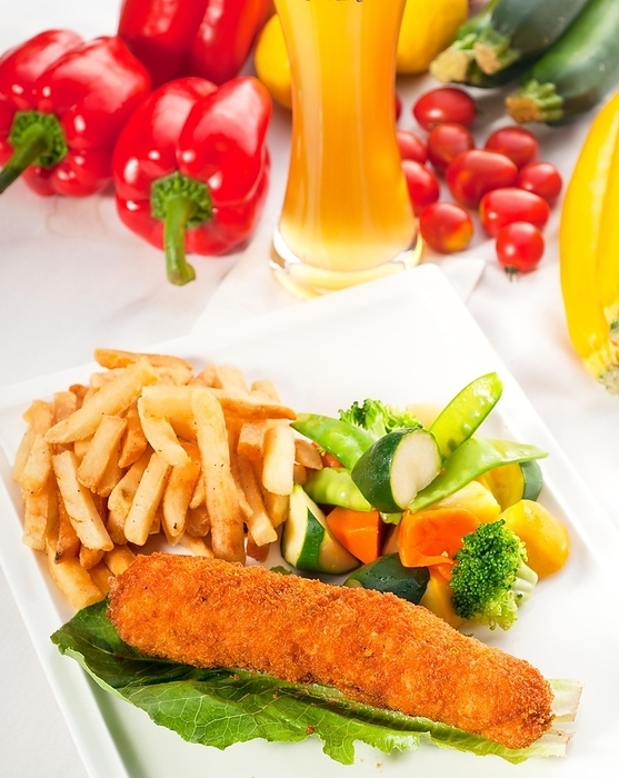 Fresh breaded chicken breast roll and vegetables, with lager beer and fresh vegetables on background, food photography, by keko64