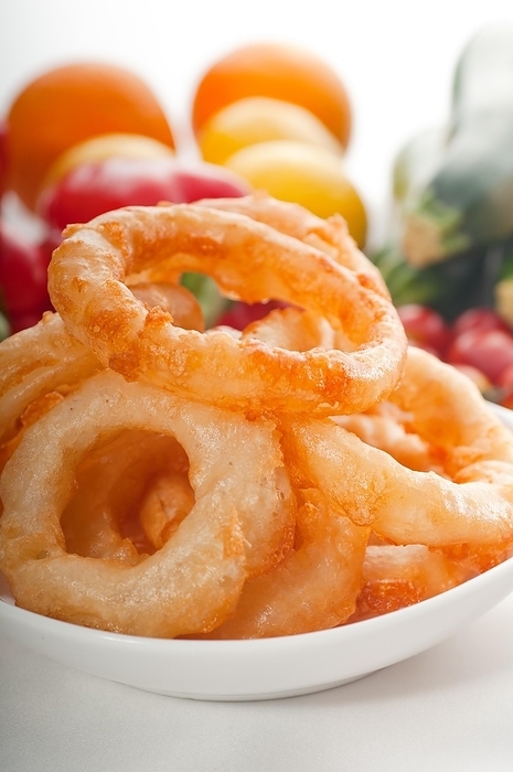 Golden deep fried onion rings served with mayonnaise dip and fresh vegetables oln background, MORE DELICIOUS FOOD ON PORTFOLIO, food photography, by keko64