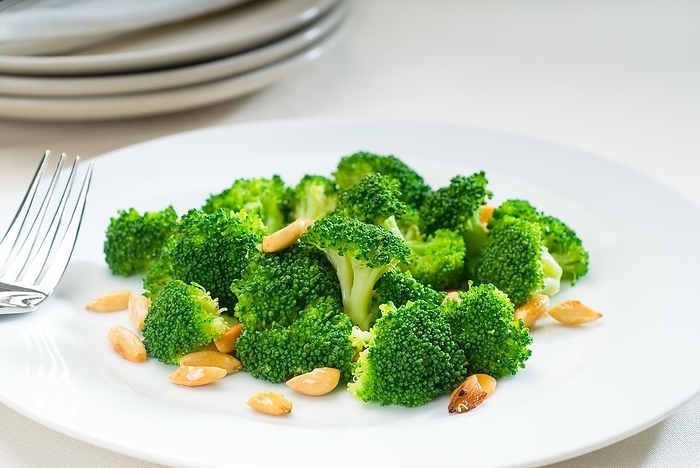 Fresh and vivid sauteed broccoli and almonds very ealthy food, food photography, by keko64