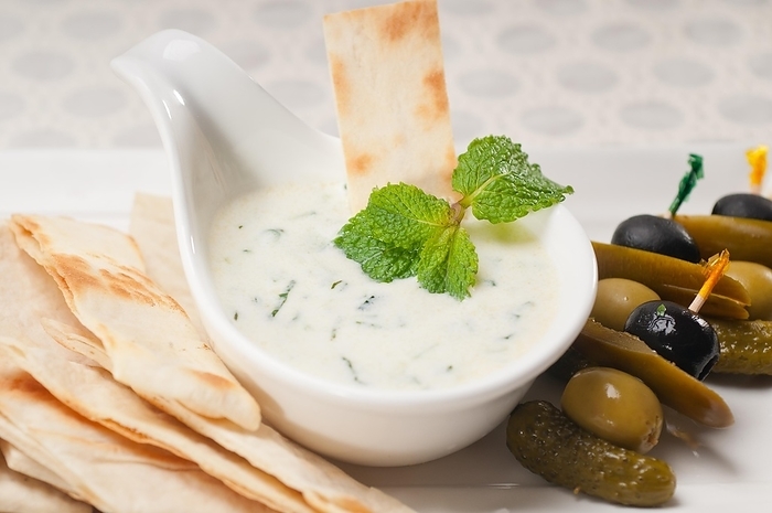 Fresh Greek Tzatziki yogurt dip and pita bread and pickels, by keko64