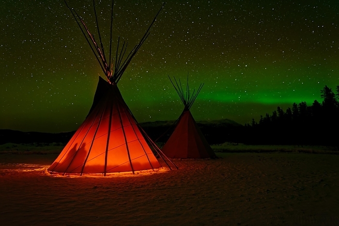 Two tents, tipis, Indian tents, front one illuminated from the inside, in a winter landscape, aurora borealis with stars in the sky, Yukon Territory, Canada, North America, by Gerhard Kraus