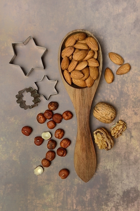 Various nuts with ladle and cookie cutters, baking ingredient, by Jürgen Pfeiffer
