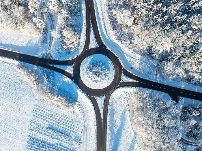 Aerial view of a snow-covered roundabout surrounded by wintry fields, Gechingen, aerial view, Black Forest, Germany, Europe, by Manuel Kamuf