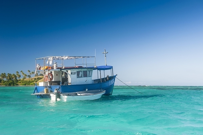 Fishing boat in the blue lagoon, Yasawas, Fiji, South Pacific, Oceania, by Michael Runkel
