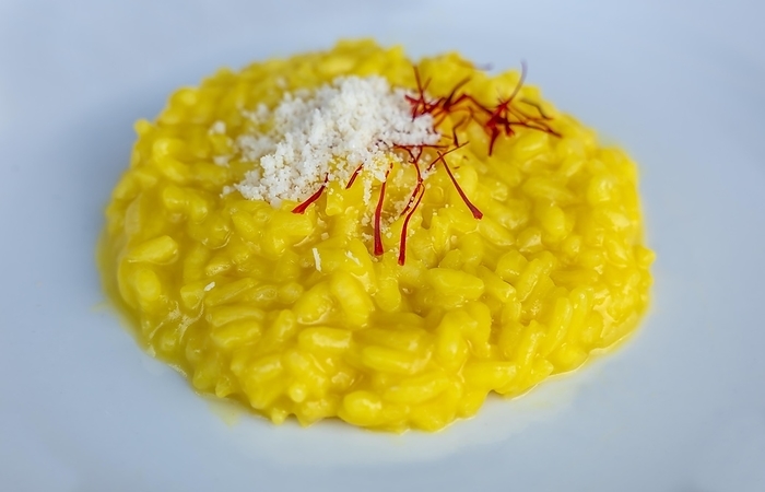 Plate with Risotto alla Milanese with Saffron and Parmesan Cheese in Lugano, Ticino, Switzerland, Europe, by Mats Silvan