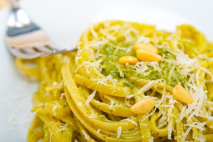 Italian traditional basil pesto pasta ingredients parmesan cheese pine nuts extra virgin olive oil garlic on a rustic table, by Francesco Perre