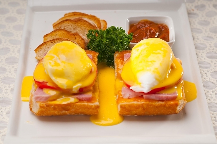Fresh eggs benedict on bread with tomato and ham, by keko64