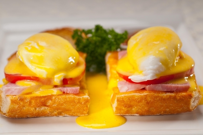 Fresh eggs benedict on bread with tomato and ham, by keko64