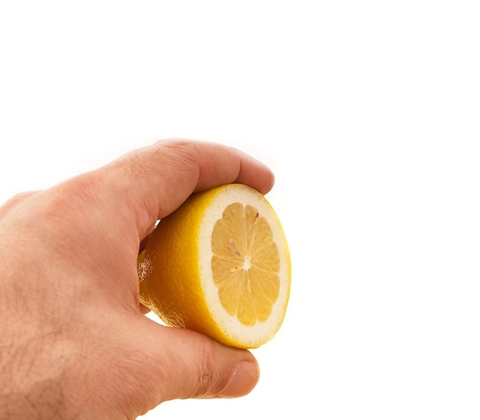 Fresh ripe lemon cutted in half hold in hand closedup, by keko64
