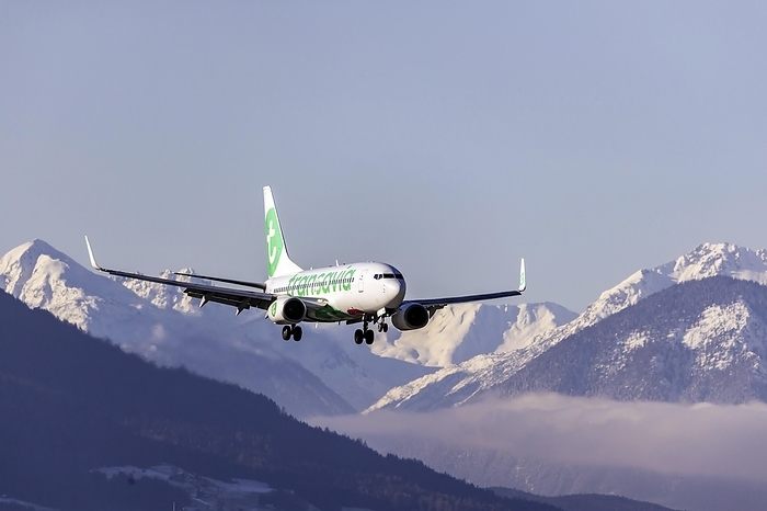 Aircraft on approach, airline Transavia Airlines, Boeing 737-700, snow lies on the mountains, Kranebitten Airport, Innsbruck, Tyrol, Austria, Europe, by Arnulf Hettrich