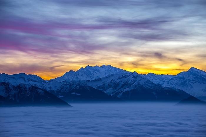 Monte Rosa snow-capped mountain in sunset, colorful sky and sea of fog, Ticino, Switzerland, Europe, by Mats Silvan