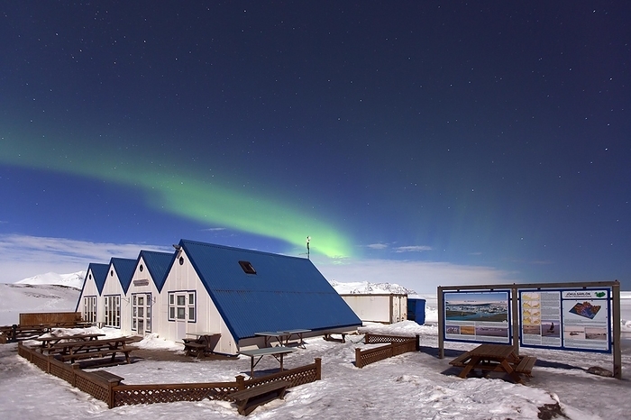 Iceland Northern Lights, Aurora borealis, weather phenomenon showing natural light display over cabins at Joekulsarlon Lagoon in winter, Iceland, Europe, by alimdi   Arterra