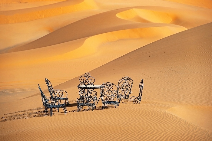 Cast iron garden table and lawn chairs in sand dunes of Erg Chebbi in the Sahara Desert near Merzouga, Drâa-Tafilalet, Errachidia, Morocco, Africa, by alimdi / Arterra / Marica van der Meer