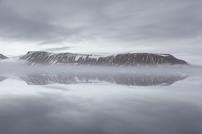 Mountains in the fog along the coast at Hinlopenstretet, Hinlopenstreet, Hinlopen strait between Spitsbergen and Nordaustlandet in Svalbard, Norway, Europe, by alimdi / Arterra / Sven-Erik Arndt